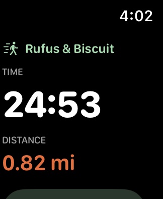 The watch mid-walk: the dogs' names, elapsed time large, distance, and a Breaks button.